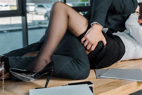 Partial View Of Passionate Businessman And Businesswoman At Workplace