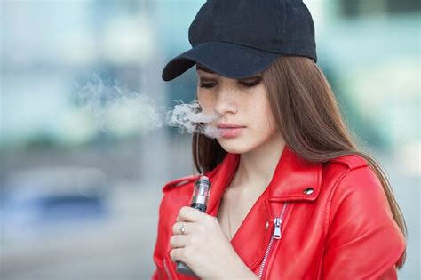 Premium Photo Young Beautiful Woman Smoking Vaping E Cigarette