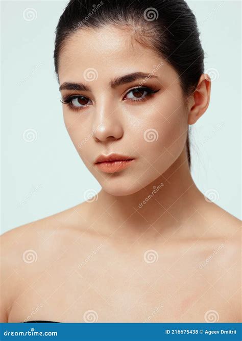 Beautiful Brunette With Evening Makeup On Her Face Naked Shoulders Pink Eyeshadow On The Eyelids