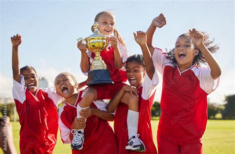 Football, team and trophy with children in celebration together as a ...