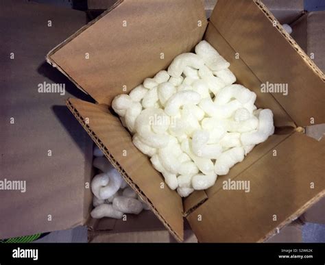 Close Up Of A Cardboard Packing Box Filled With White Styrofoam Peanuts