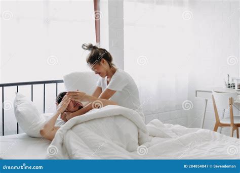 Funny Couple Wife Try To Wake Lazy Husband Up In White Bedroom Stock Image Image Of Insomnia