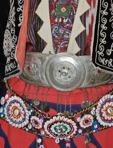 Two belts one with metal buckle one with göz motif amulet in