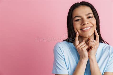 Brunette Hispanic Woman Smiling And Pointing Fingers At Her Cheeks Stock Photo Image Of Finger