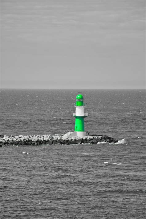 Green And White Lighthouse On The Baltic Sea Waves On The Stone Edge