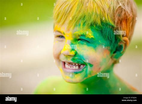 Portrait Of Happy Boy With Blue Eyes With Strabismus Smeared With