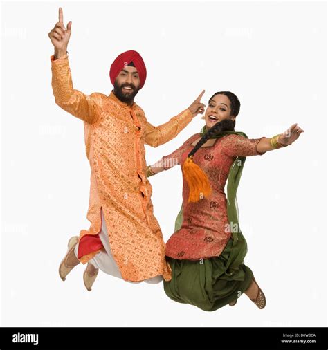 Sikh Couple Doing Bhangra The Folk Dance Of Punjab In India Stock Photo