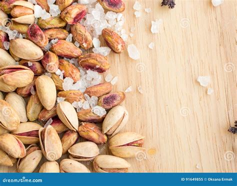 Heap Of Inshell Pistachios And Peeled Pistachios With Large Salt