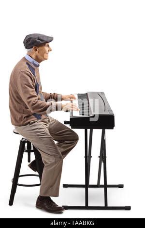 Cheerful Senior Man Playing A Digital Keyboard Piano Isolated On White