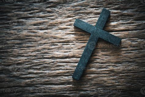 A wooden Christian cross crucifix on a grunge board background. Wooden ...