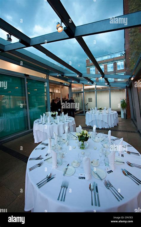 Setting of wedding dinner on round white tables Stock Photo - Alamy
