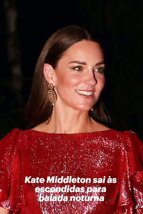 A Woman In A Red Dress Smiles At The Camera