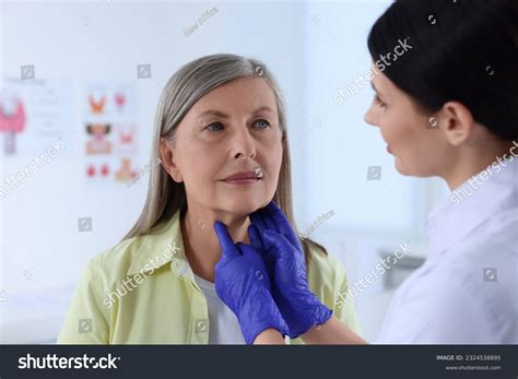 Endocrinologist Examining Thyroid Gland Patient Hospital Stock Photo