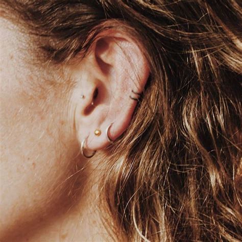 A Close Up Of A Person With Ear Piercings