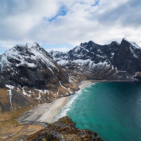 Spring Snow And Kvalvika Beach Seen From Ryten Mountain Summit