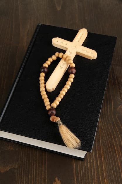 Premium Photo Bible Rosary And Cross On Wooden Table Closeup