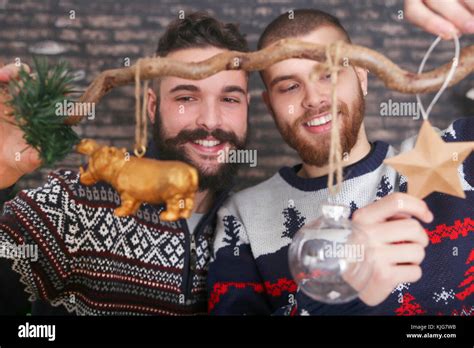 Gay Couple Decorating A Branch At Christmas Time Stock Photo Alamy