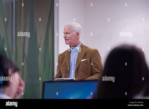 Handsome Mature Teacher And Students In Computer Lab Classroom Stock Photo Alamy