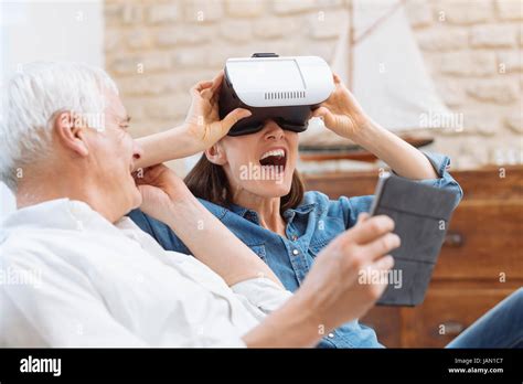 Mature Couple Using Digital Tablet And Virtual Reality Headset In Living Room Stock Photo Alamy