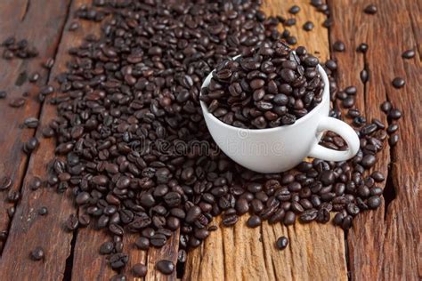 Close Up Shot Of Dark Roasted Coffee Bean In White Ceramic Cup O Stock