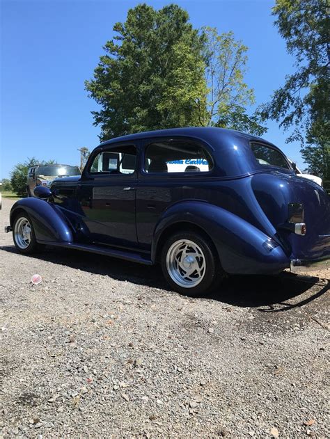 An Antique Car Is Parked On The Gravel