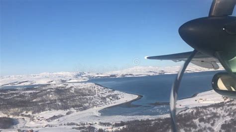 View From Plane Window Over Snow Covered Troms Norway Stock Photo