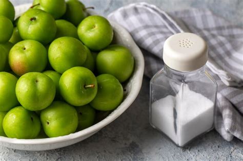 Premium Photo | Green fresh plums and salt