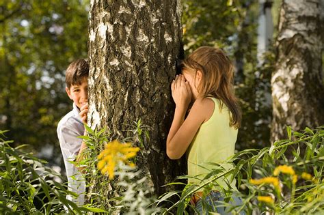 Girl And Boy Playing Hide And Seek License Image Lookphotos