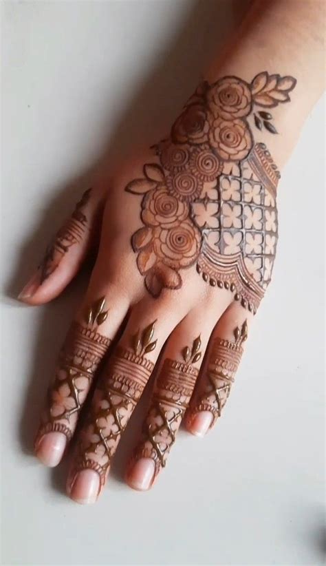 A Woman S Hand With Hennap On It And Flowers Around The Wrist