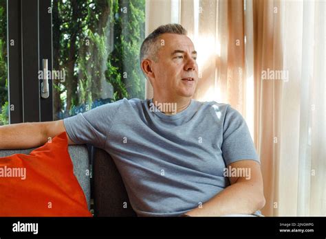 Mature Thoughtful Business Man Sitting On Soft Chair In Cafe And Looking At Window Handsome