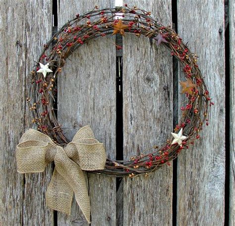 Barb Wire Wreath With Burlap Bow And Red Berries And Rusty Stars On