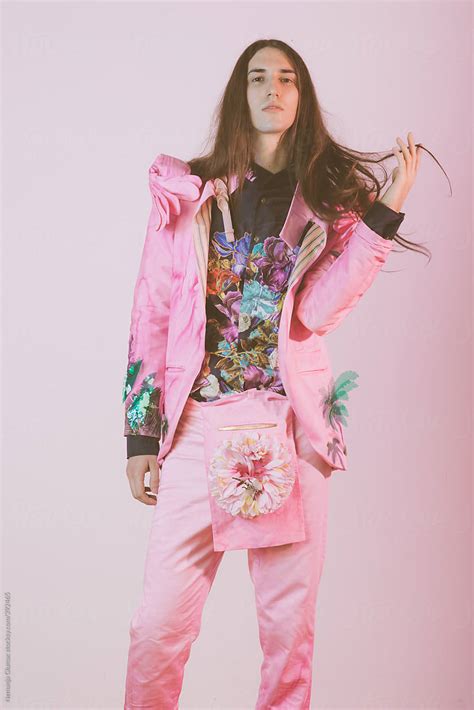 Male Fashion Model With Long Hair Posing In Pink Floral Costume By