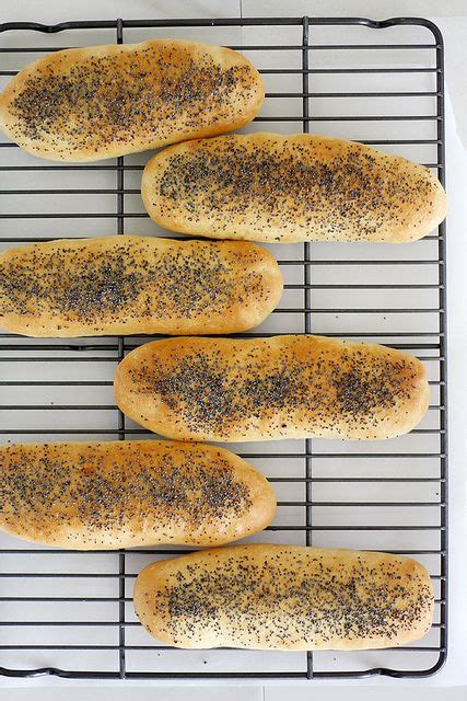 four loaves of bread sitting on top of a cooling rack