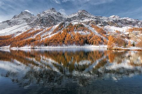 Premium Photo | Engadine valley in switzerland. autumn reflection in the lake