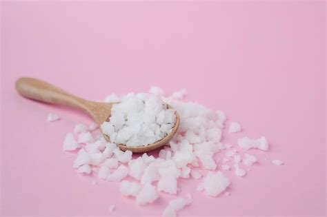 Premium Photo Sea Salt In A Wooden Spoon On Pink Background For