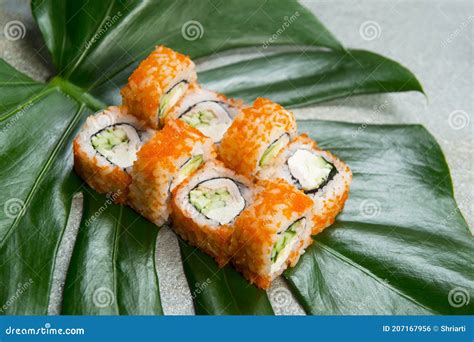 Sushi Roll With Smoked Chicken In Tobiko Flying Fish Roe Served On