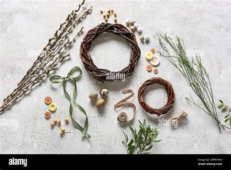 Composition With Easter Wreaths Bow Pussy Willow Branches And Buttons On Light Background