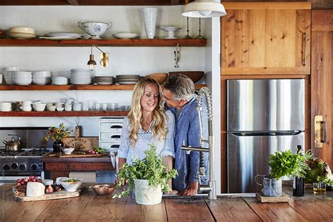 Mature Couple Cooking In The Kitchen Together By Stocksy Contributor