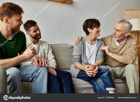 Gay Couple Sits Parents Couch Engaging Warm Intimate Conversation Stock Photo HayDmitriy