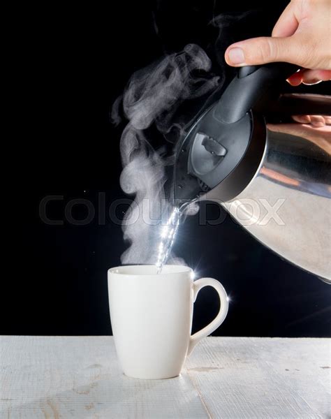 Kettle Pouring Boiling Water Into A Cup Stock Image Colourbox