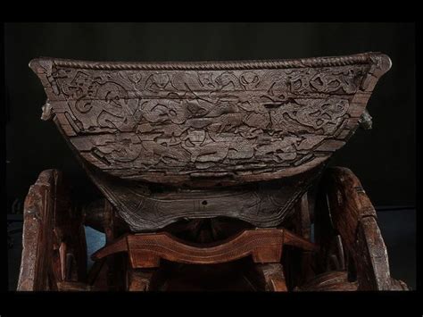 An Old Wooden Chair With Intricate Carvings On Its Back And Seat In