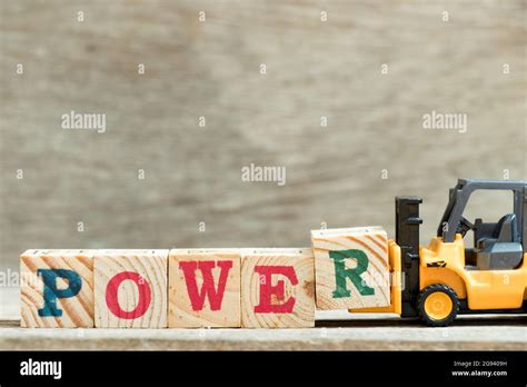 Toy Yellow Forklift Hold Block Letter R To Complete Word Power On Wood