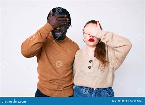 Interracial Couple Wearing Casual Clothes Covering Eyes With Hand