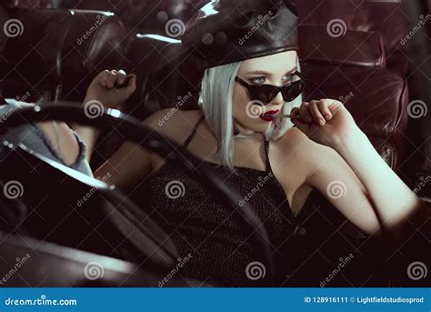 Beautiful Stylish Blonde Girl Holding Cigarette And Looking Away While Sitting Stock Image