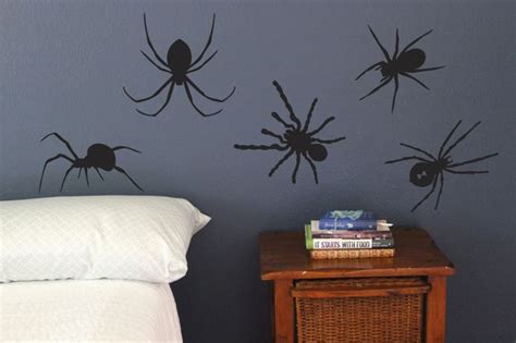 Three Black Spider Wall Decals On The Side Of A Bed