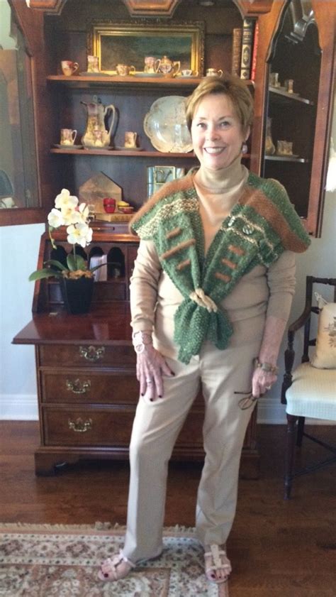 A Woman Standing On Top Of A Rug In Front Of A Wooden Dresser And Bookcase