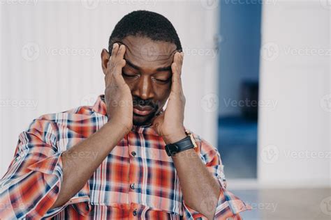 Tired Upset African American Man Suffer Headache With His Head In His