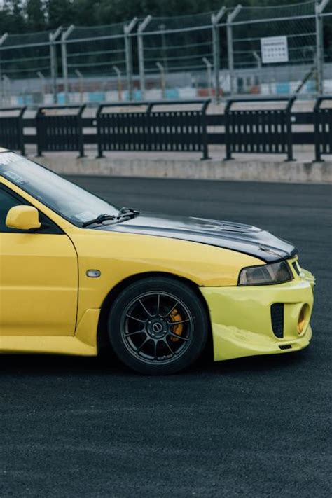 Modified Mitsubishi Lancer Evo Standing on the Race Track · Free Stock Photo