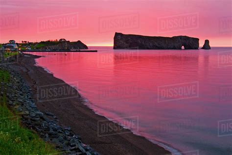 Red sunrise at Perce Rock, Quebec - Stock Photo - Dissolve