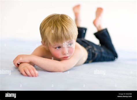 Little Boy Laying On Floor Stock Photo Alamy